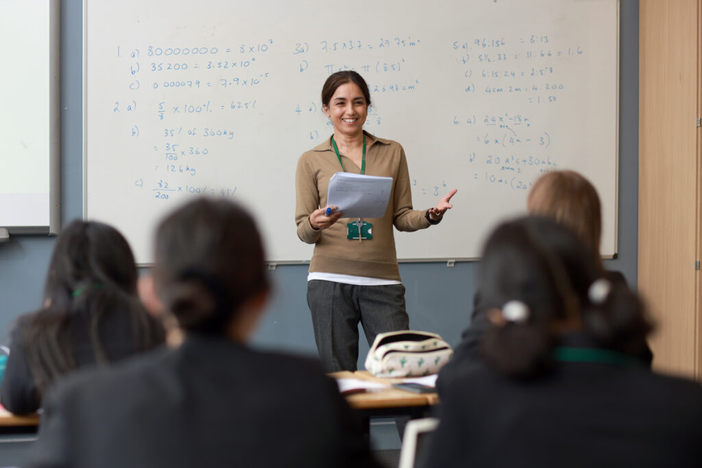 a picture of a maths teacher teaching the class