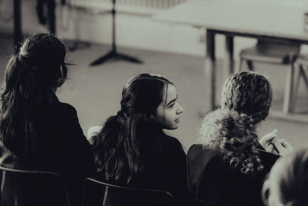 a close up of three students sat in class