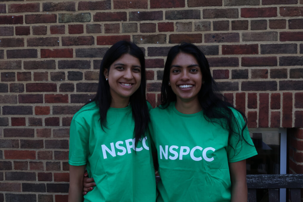 A picture of two students with NSPCC t-shirts on
