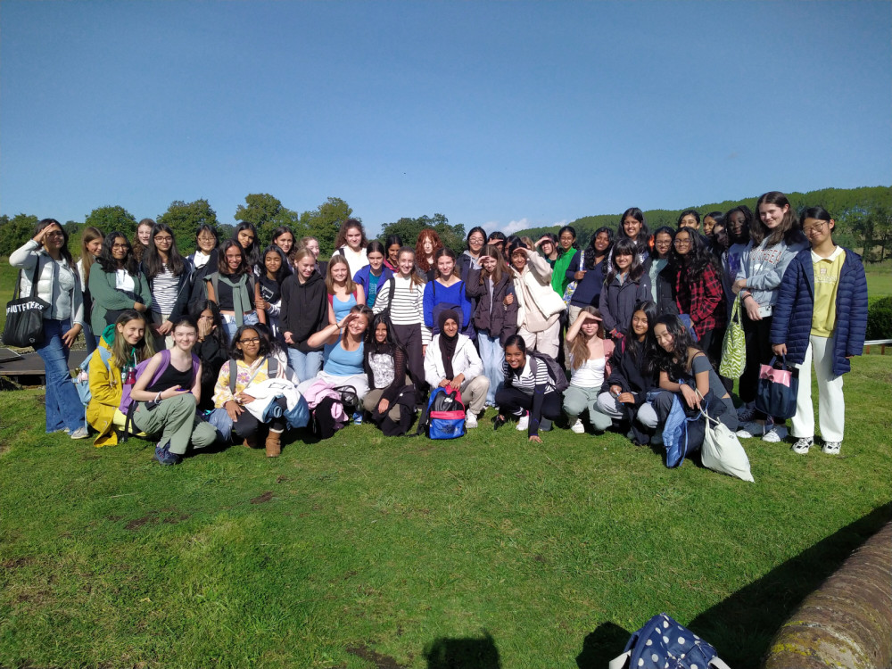 group photo of students outside in a field